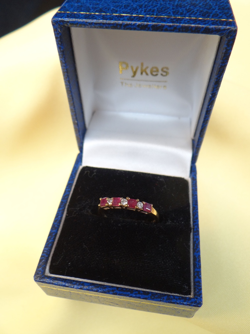 9CT GOLD RUBY & DIAMOND SEVEN STONE RING, ring size M, 1.3gms, in square blue ring box Condition: