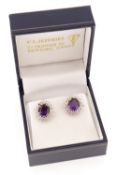 PAIR OF WHITE METAL AMETHYST & DIAMOND EARRINGS, the central amethysts surrounded by circular and