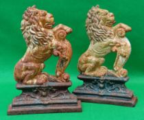 TWO SIMILAR CAST IRON 'RAMPANT LION' DOOR STOPS, on stepped rectangular bases, 34cms high each (2)