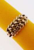 18CT GOLD 'KEEPER' RING, of ball and weave design, ring size L, 5.8gms