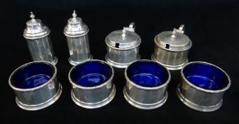 GEORGE V SILVER 8 PIECE CRUET SET, Birmingham 1930, of panelled for with laurel wreath rim,