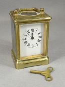 FRENCH BRASS CARRIAGE CLOCK having white enamel dial with Roman numeral chapter ring, engraved '