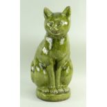 LARGE EWENNY POTTERY MODEL OF A SEATED CAT in green glaze, incised decoration, geometric design