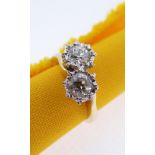 18CT GOLD TWO STONE DIAMOND RING, the two primary stones (totalling 0.7cts approximately) illusion