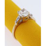 18CT GOLD DIAMOND RING, the central stone (0.7cts approx.) flanked by diamond tapering baguette