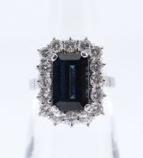 18CT WHITE GOLD SAPPHIRE & DIAMOND CLUSTER RING, the central sapphire (10 x 6mms) surrounded by