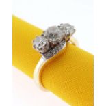 18CT GOLD THREE STONE DIAMOND RING, the three primary stones (totalling 1.0cts approximately) on a