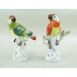 TWO MEISSEN PORCELAIN MODELS OF PARROTS, 20th Century, perched on tree stumps with sprouting leaves,