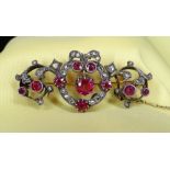 YELLOW & WHITE METAL SET DIAMOND & RUBY BAR BROOCH of naturalistic bow, scroll and leaf design, 11.