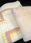 TWO VINTAGE PRINTED QUILTS, probably Welsh, pink floral 203 x 163cms (solied, holes), yellow