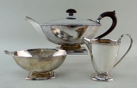 GEORGE V SILVER THREE-PIECE ART DECO TEA SERVICE, Birmingham 1933 by Adie Brothers, rims chased with