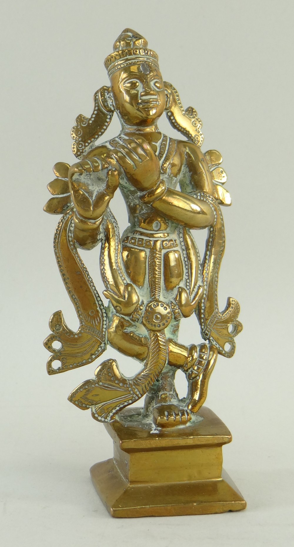 BRONZE FIGURE OF KRISHNA PLAYING THE FLUTE on stepped plinth base, 15cms high Condition: flute