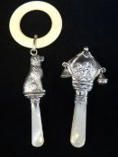 TWO SILVER MOUNTED BABY RATTLES / TEETHERS, one George V decorated with titled scene 'Jack & Jill'