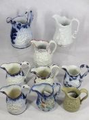 ANTIQUE RELIEF MOULDED JUGS (9) - all having cherubic decoration with flow blue, lustre and