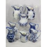 VICTORIAN FLOW BLUE & LUSTRE HIGHLIGHTED JUGS (8) - most having patterns in relief depicting