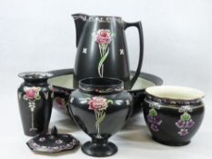 SHELLEY CARNATION & OTHER FLORAL DECORATED BLACK POTTERY ITEMS - a wash jug and bowl, three