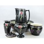 SHELLEY CARNATION & OTHER FLORAL DECORATED BLACK POTTERY ITEMS - a wash jug and bowl, three