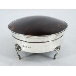 A CIRCULAR SILVER & TORTOISE SHELL RING BOX - four bead and claw supports with hinged lid with domed