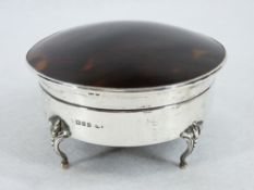 A CIRCULAR SILVER & TORTOISE SHELL RING BOX - four bead and claw supports with hinged lid with domed