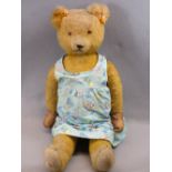 MID-CENTURY MOHAIR TEDDY BEAR - in a child's colourful Boots chemist's dress, the Teddy quite