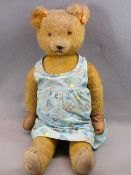 MID-CENTURY MOHAIR TEDDY BEAR - in a child's colourful Boots chemist's dress, the Teddy quite