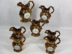 VICTORIAN COPPER LUSTRE CLOCK JUGS (7) - all but one having figural details verso Oriental style,