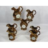 VICTORIAN COPPER LUSTRE CLOCK JUGS (7) - all but one having figural details verso Oriental style,