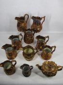 VICTORIAN COPPER LUSTRE WARE - 10 various jugs and a relief moulded teapot and cover, the jugs