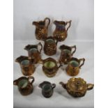 VICTORIAN COPPER LUSTRE WARE - 10 various jugs and a relief moulded teapot and cover, the jugs