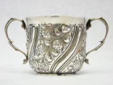 A SILVER TWIN-HANDLED CUP - with floral and swirled decoration, 4.3 ozt, London 1897