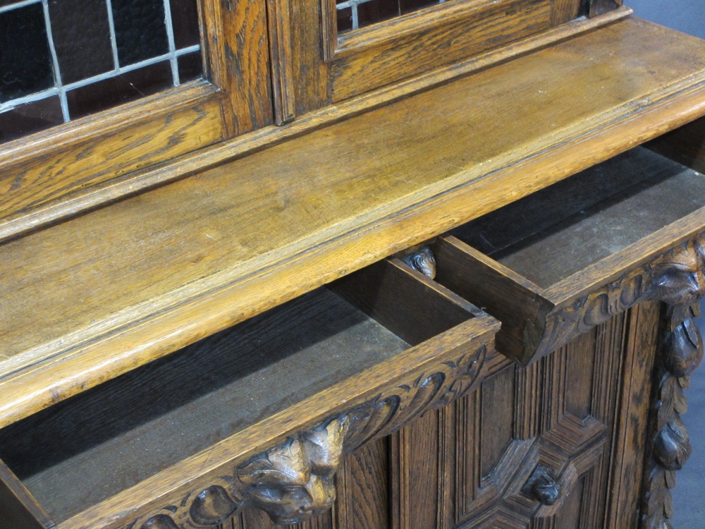 CONTINENTAL STYLE CARVED OAK BOOKCASE SIDEBOARD - with leaded coloured glass upper doors, lion mask, - Image 8 of 11