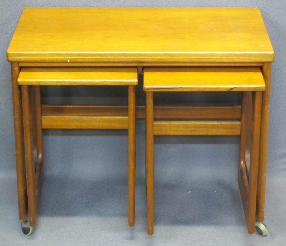 A H McINTOSH & CO SCOTLAND MID-CENTURY TEAK NEST OF THREE TABLES - the largest with swivel