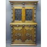 CONTINENTAL STYLE CARVED OAK BOOKCASE SIDEBOARD - with leaded coloured glass upper doors, lion mask,
