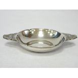 A SMALL SILVER BONBON/SWEETMEATS DISH with floral and Celtic style patterned shaped handles,