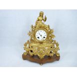 19TH CENTURY FRENCH GILT METAL MANTEL CLOCK - Rococo style on a shaped walnut base with bun feet