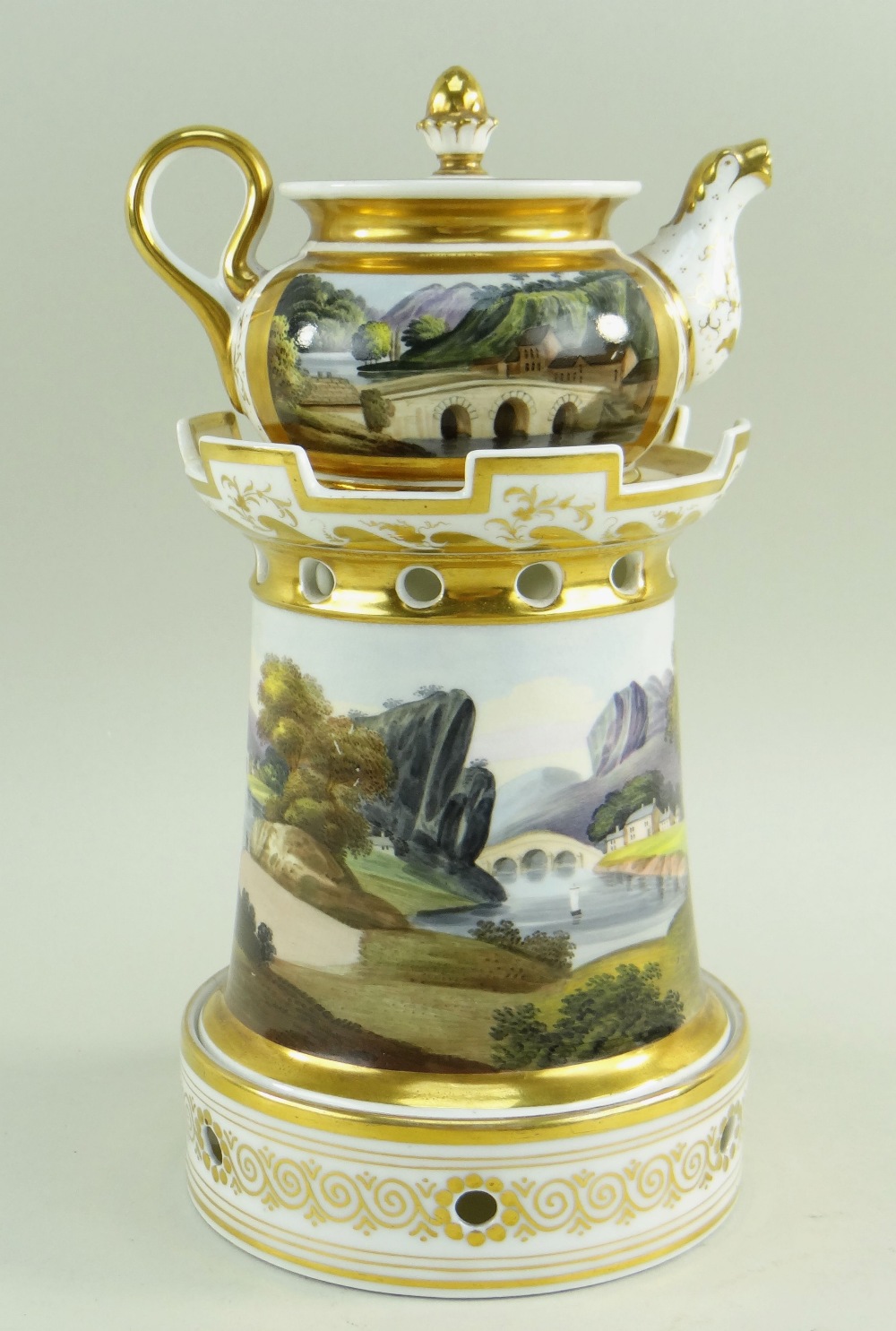 A WELSH LANDSCAPE ENGLISH PORCELAIN VEILLEUSE (tea-pot and warming stand) comprising miniature