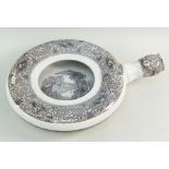 A RARE LLANELLY POTTER BEDPAN IN THE MILAN TRANSFER of wheel form with nozzle, the interior with a