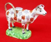 SWANSEA PEARLWARE COW CREAMER typically decorated with lilac and iron red lustre, standing on a '