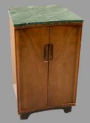 MID-CENTURY WALNUT GREEN MARBLE TOPPED SIDE CABINET having twin concave doors and interior shelving,