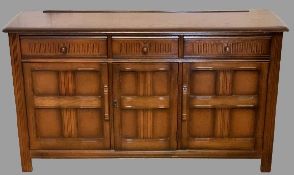 PRIORY STYLE OAK SIDEBOARD BASE having three frieze drawers and three lower cupboard doors, on stile