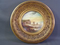 DECORATIVE CHINA PLATE marked 'Oriental Ivory' having a painted coastal scene within a gilt frame,