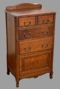 VINTAGE OAK CHEST with cabinet base, the shaped railback over a moulded edge top with two short