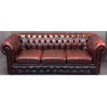 RED LEATHER UPHOLSTERED CHESTERFIELD SETTEE - 3 seater, 71cms H, 210cms W, 54cms seat D