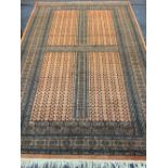 EASTERN STYLE WOOLLEN CARPET - rust ground with repeating central block and traditional patterned