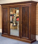 CIRCA 1900 MAHOGANY TRIPLE WARDROBE with dentil carved cornice and large central mirrored door