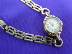 A LADY'S ROTARY 9CT GOLD CIRCULAR DIAL WRISTWATCH - with rolled gold three row bracelet, 12grms