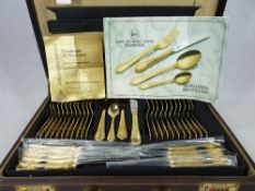 BRIEFCASE SET OF 23/24CT GOLD PLATED CUTLERY by Carl Schmidt Sohn Solingen - 70 pieces, dishwasher