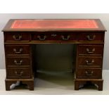 REPRODUCTION DESK with tooled red leather effect top, twin pedestals and a central drawer, 77cms