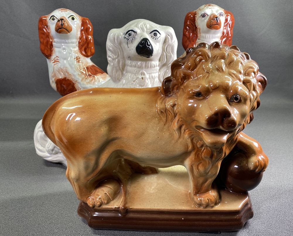 STAFFORDSHIRE LION, a pair of red and white Staffordshire comforter dogs, 34cms H and another