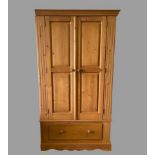 PINE WARDROBE - two door and a base drawer with turned knobs, 193cms H, 107cms W, 60cms D